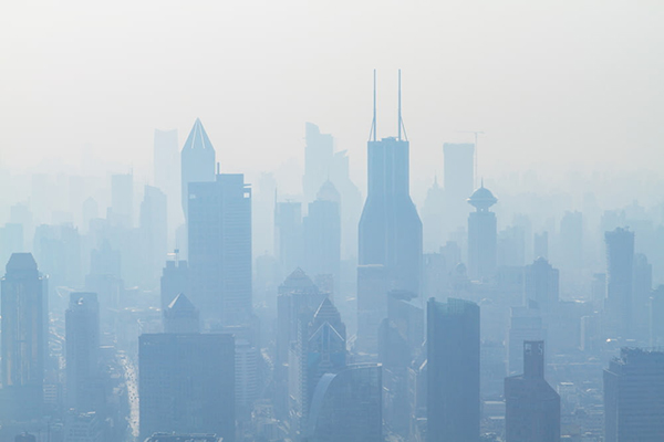 aerial view of high-rise buildings covered with smo.jpg